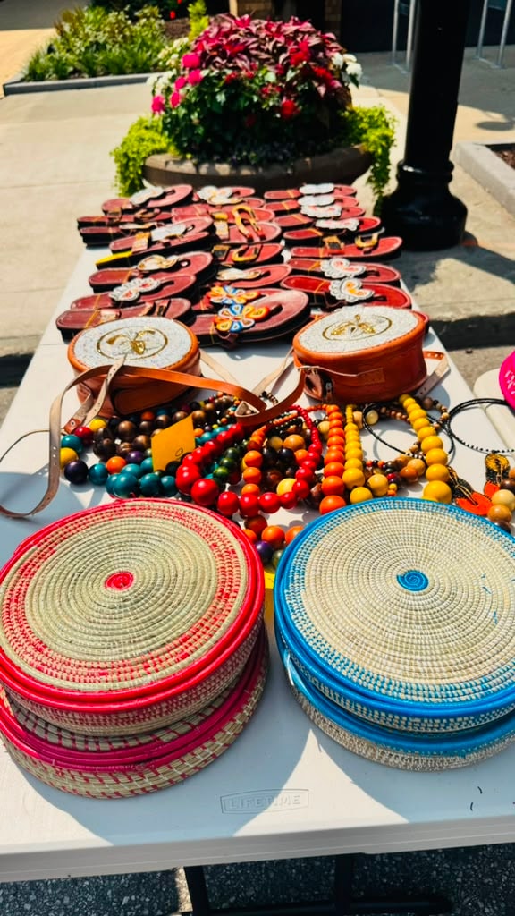 Colorful African handmade baskets, beaded jewelry and leather goods displayed at a vendor table