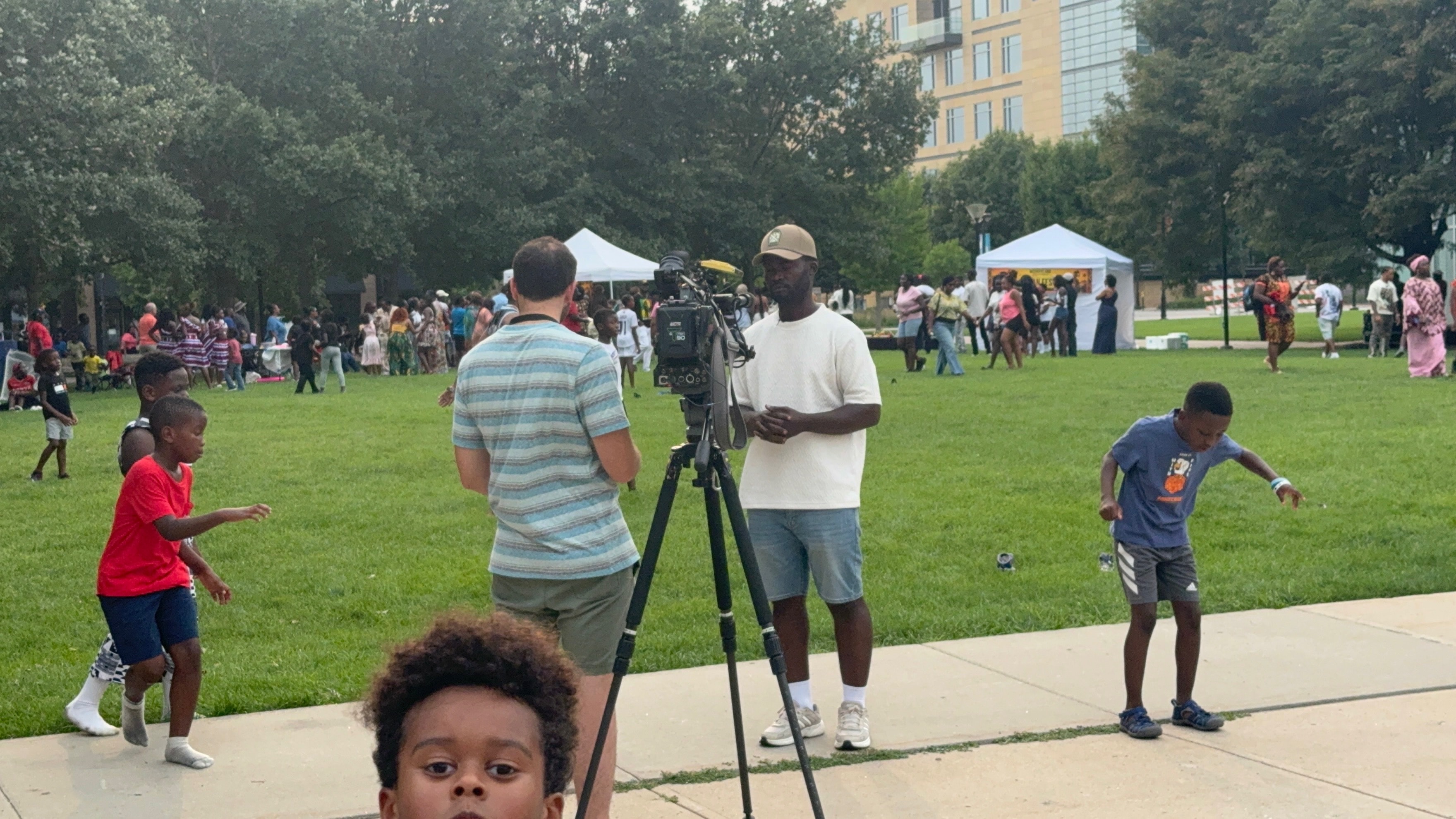 Media crew filming the festival crowd at Western Gateway Park
